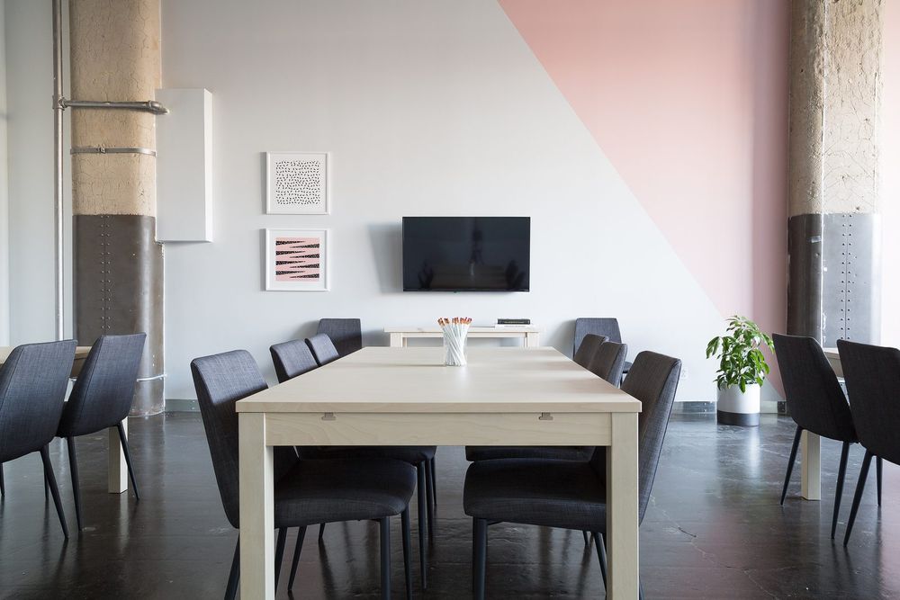 Meeting space with exposed structure and feature wall